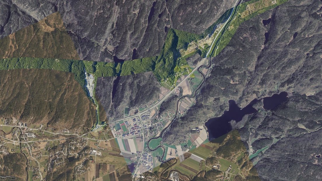 Ortofoto over Søgne som er sammensatt av flere prosjekter med ulik fargeuttrykk, som gir en lappeteppe-effekt.